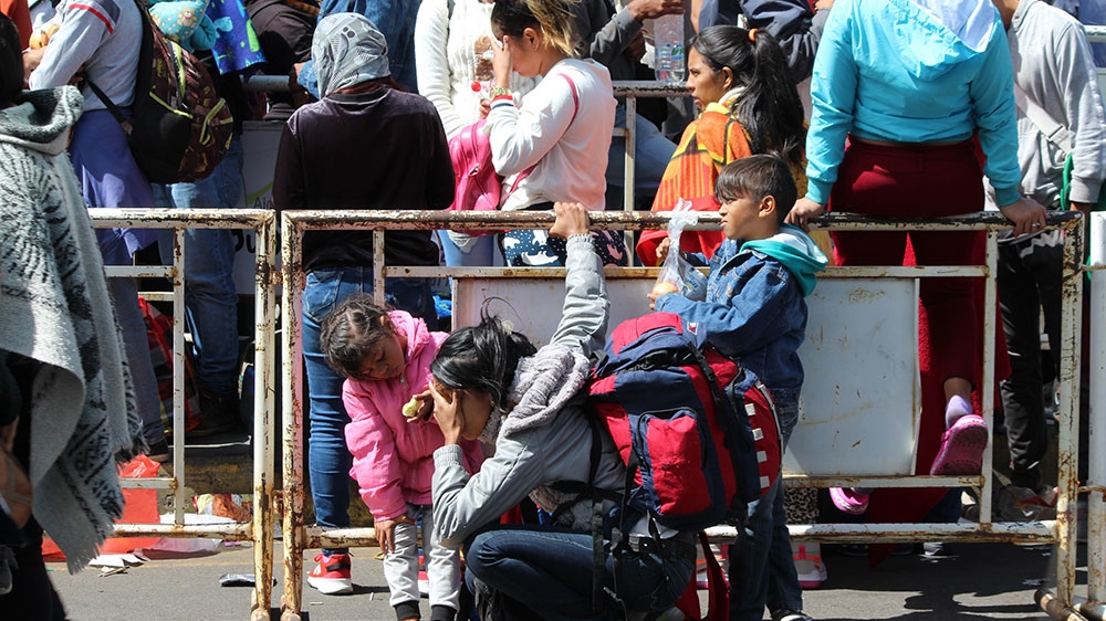 Venezuelans wait in line at the Colombia-Ecuador border