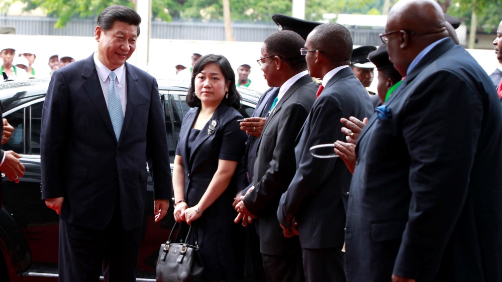 China''s President Xi Jinping (L) arrives for the opening ceremony of