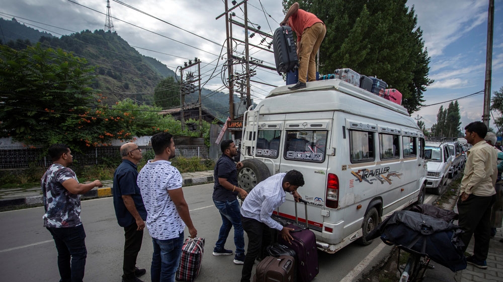Indian tourists load their luggage onto a passenger vehicle as they prepare to leave Srinagar [Reuters]