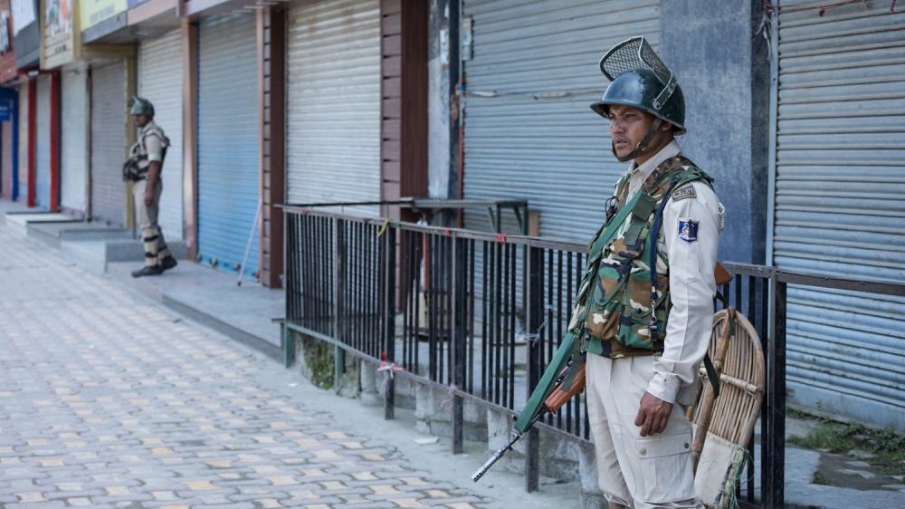 Indian troops patrol the deserted streets of Srinagar during a significant security lockdown
