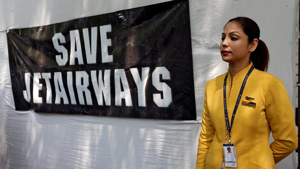 Jet Airways staffer w/signage in New Delhi