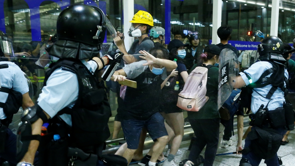 Police used batons and tear gas inside the airport on Wednesday during scuffles with protesters