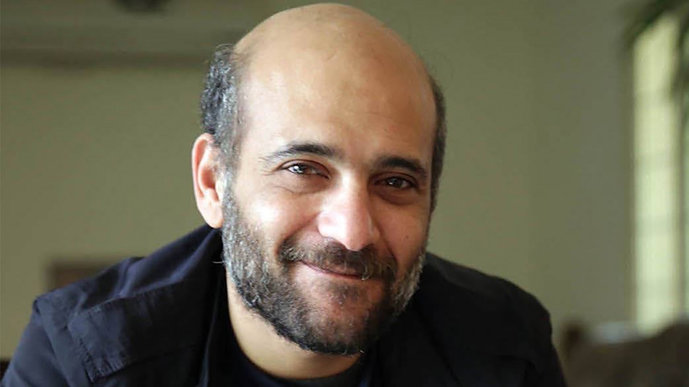 Ramy Shaath smiles at the camera.