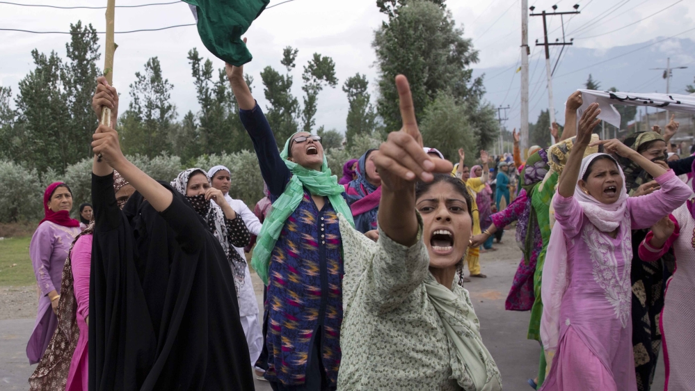 Kashmiri women shout slogans while marching on a street after Friday prayers in Srinagar