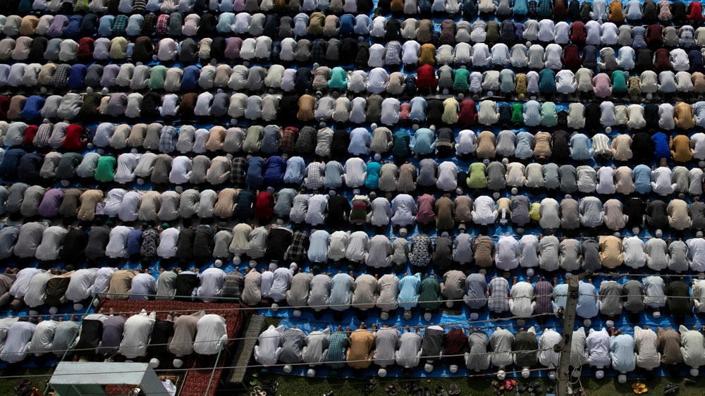 Kashmiris offer Eid al-Adha prayers at a mosque during restrictions in Srinagar