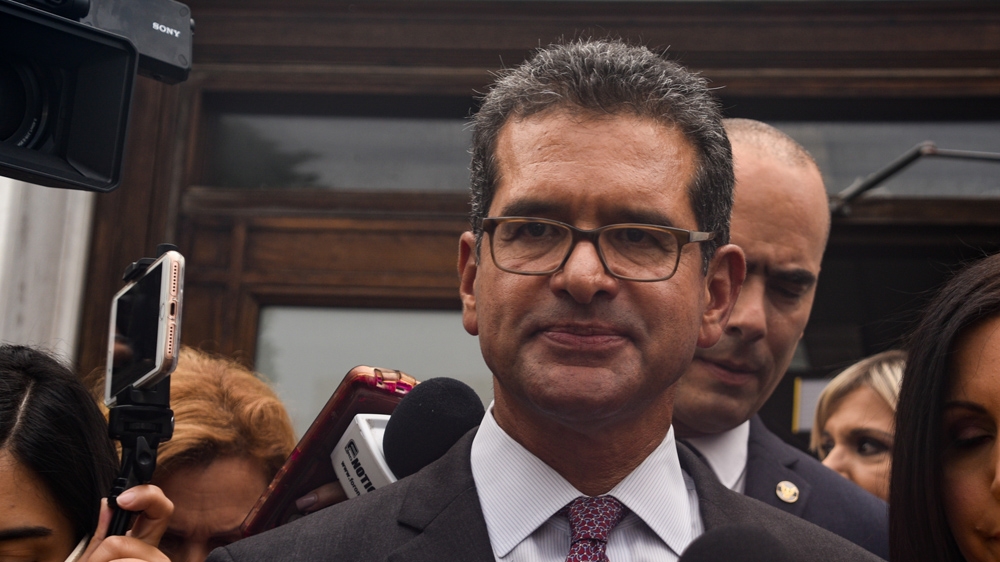 Pedro Pierluisi is surrounded by the media during a special session of the Legislative Assembly