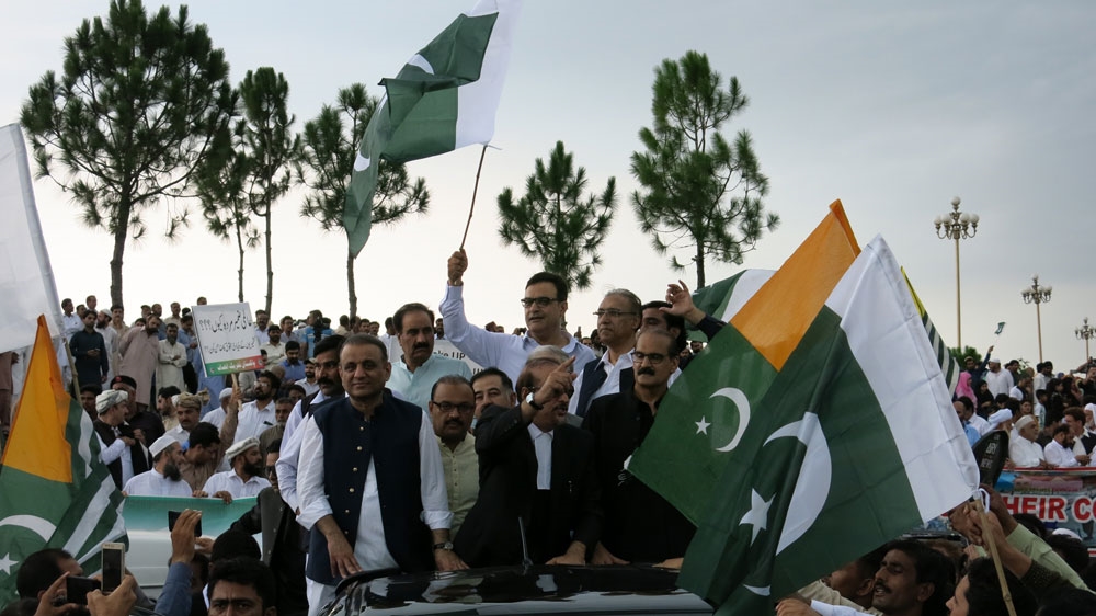 Babar Awan, a senior leader of the ruling PTI party, addresses supporters outside parliament