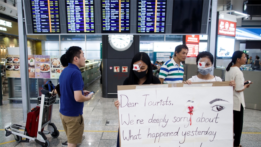 Anti-government demonstrators apologize for yesterday''''s clashes with police at the airport in Hong Kong China August 14, 2019. REUTERS/Thomas Peter