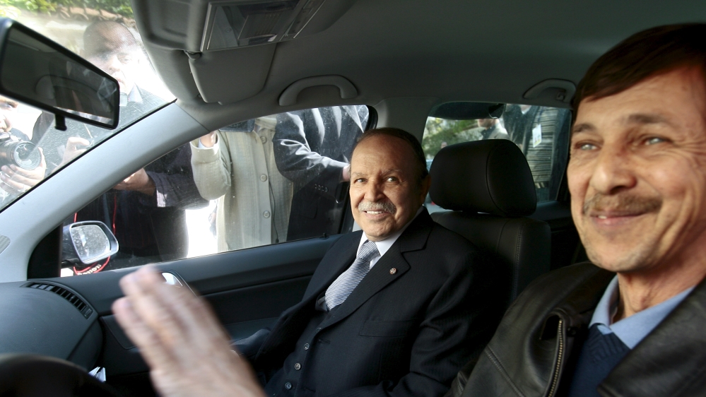 Algeria''s President Abdelaziz Bouteflika smiles as he arrives with his brother Said at his campaign''s communications department during a surprise visit in Algiers