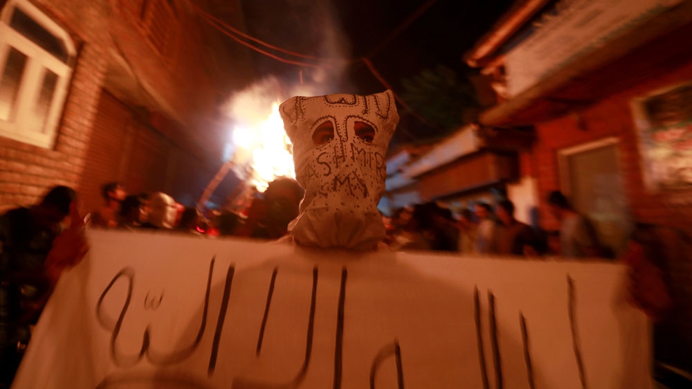 A masked Kashmiri man takes part in a protest during restrictions in Srinagar