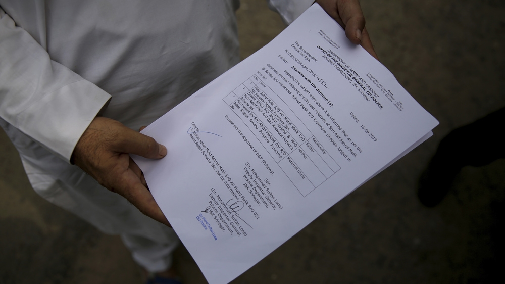 Mohammad Ashraf Malik, a Kashmiri whose son is imprisoned in Agra Central Jail, shows a permission letter to meet his son
