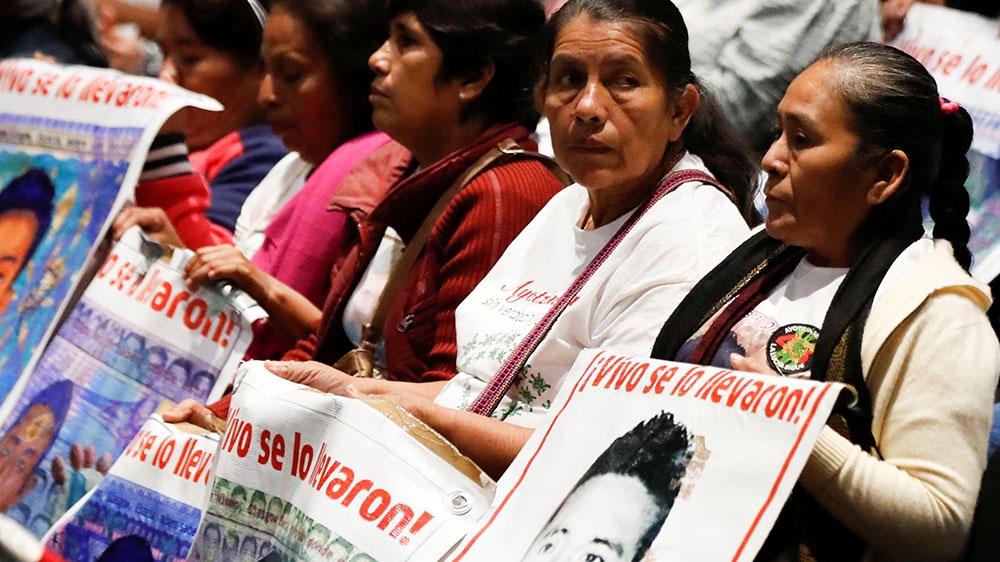 Relatives of missing students of the Ayotzinapa Teacher Training College hold posters with their images during a session on the fifth anniversary of their disappearance in Iguala in the state of Guerrero, at the Congress building, in Mexico City, Mexico
