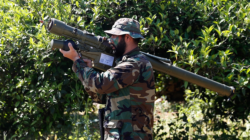 A Hezbollah fighter holds an Iranian-made anti-aircraft missile as he takes his position between orange trees, at the coastal border town of Naqoura, south Lebanon, Thursday, April 20, 2017. (AP Photo