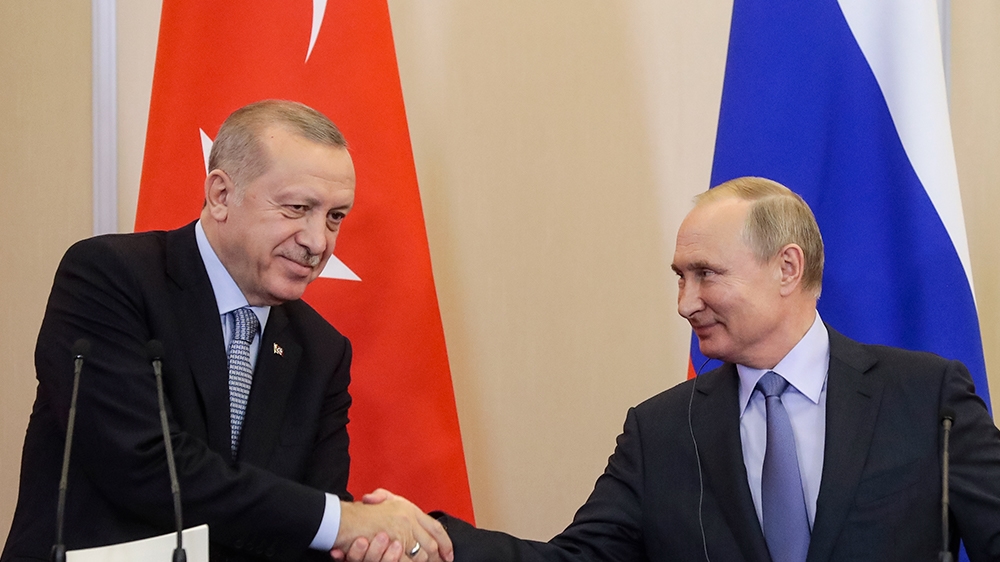 Russian President Vladimir Putin, right, and Turkish President Recep Tayyip Erdogan shake hands after their joint news conference following their talks in the Bocharov Ruchei residence in the Black Se