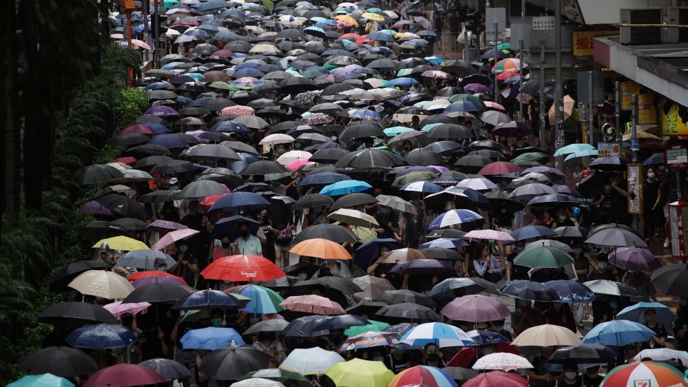 Anti-government protesters took to the streets peacefully on Sunday despite heavy rain.