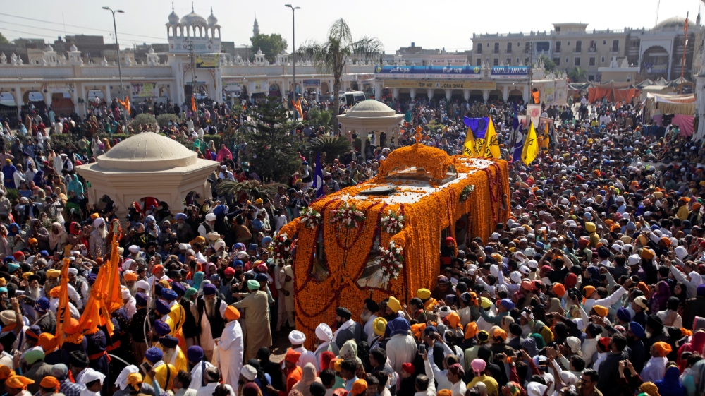 Sikh devotees attend a religious procession to mark the 549th birth anniversary of Guru Nanak Dev Ji, founder of Sikhism, in Nankana Sahib near Lahore