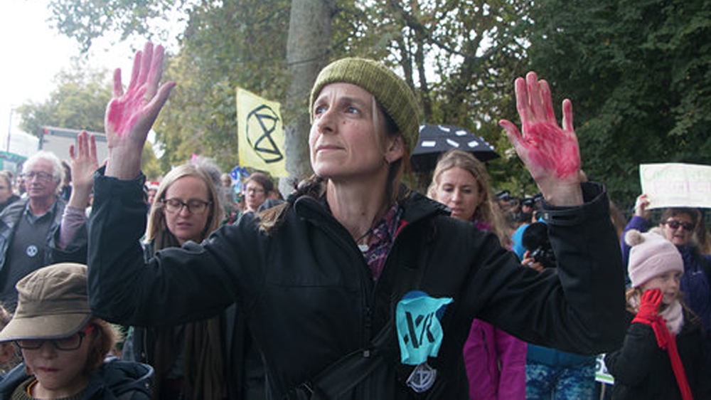 Red-painted hands held up high symbolise taking responsibility for one’s action, protesters say
