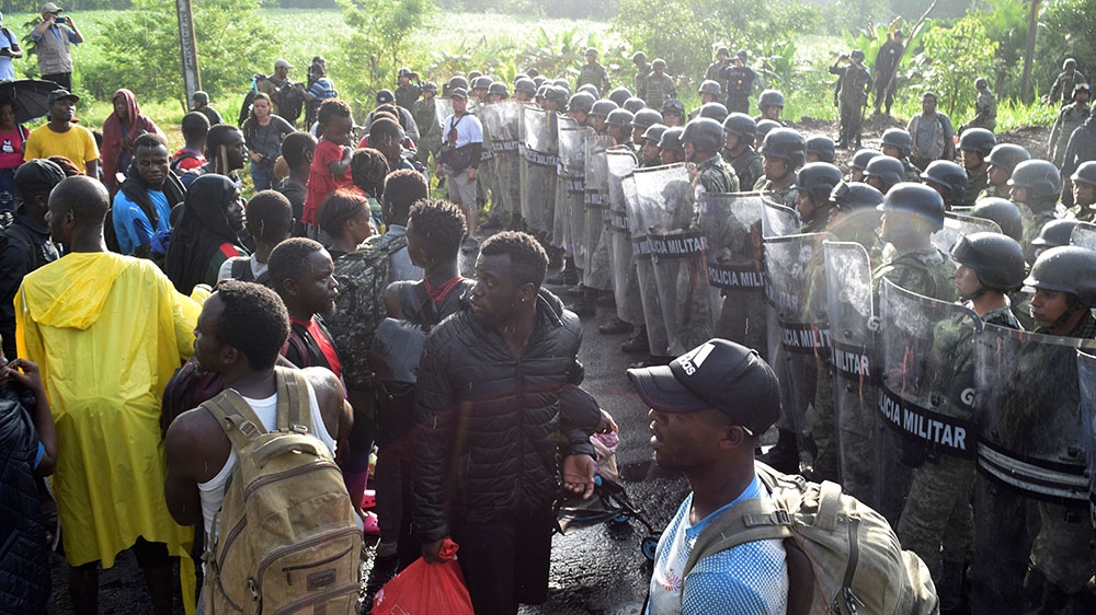 Members of the National Guard block a road during an operation to halt a caravan of migrants and asylum seekers from Africa, the Caribbean and Central America, hours after they embarked towards the US