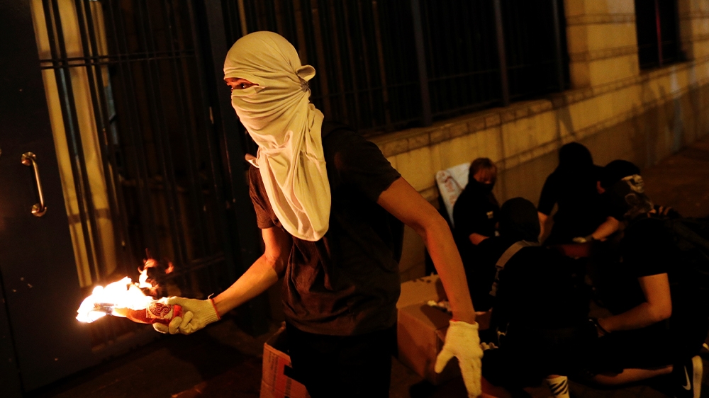 An anti-government protester with a petrol bomb outside a police station in Tsuen Wan in Hong Kong overnight.