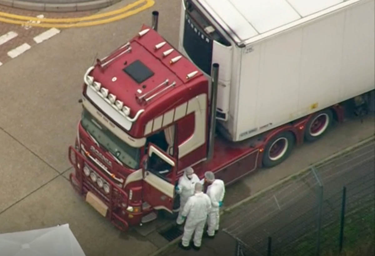 An aerial view as police forensic officers attend the scene after a truck was found to contain a large number of dead bodies, in Thurrock, South England, early Wednesday Oct. 23, 2019. Police in south