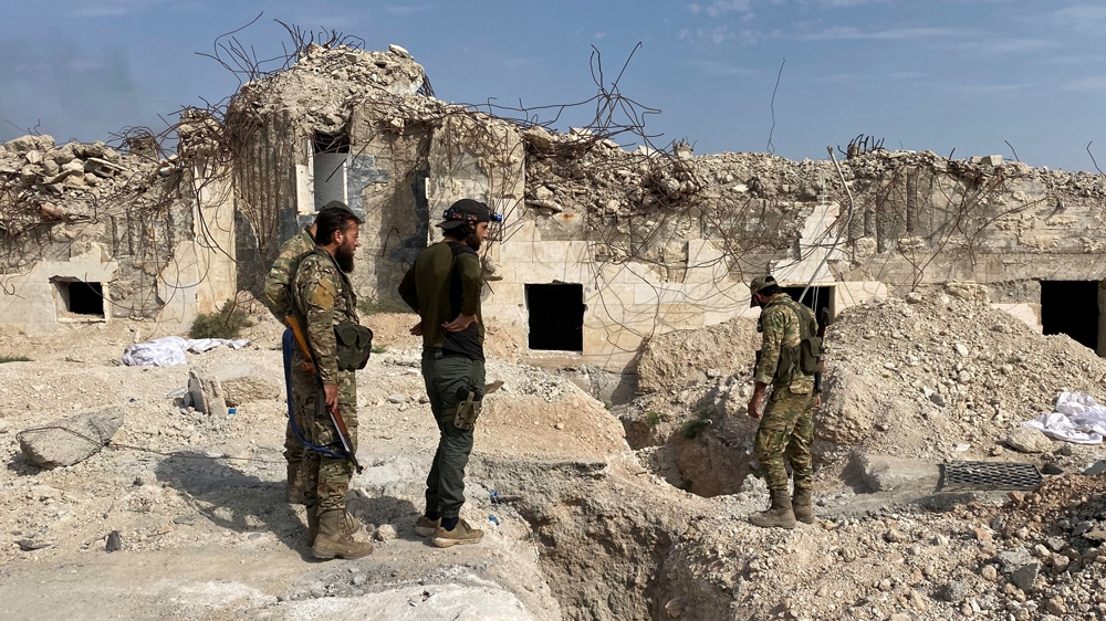 Turkey-backed Syrian rebel fighters stand near underground tunnels said to be made by the Syrian Democratic Forces (SDF) in Tal Abyad, Syria October 17, 2019. REUTERS/Mahmoud Hassano
