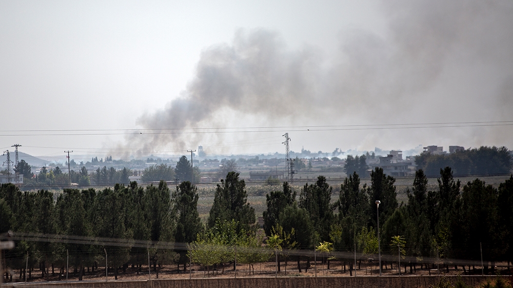 Smoke rises from the northeastern Syrian town of Tal Abyad [Hosam Salem/Al Jazeera] [Al Jazeera]