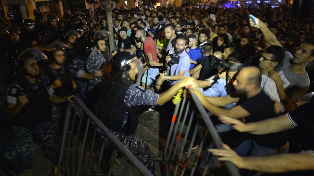 Protesters clash with police in downtown Beirut during protests on Thursday night