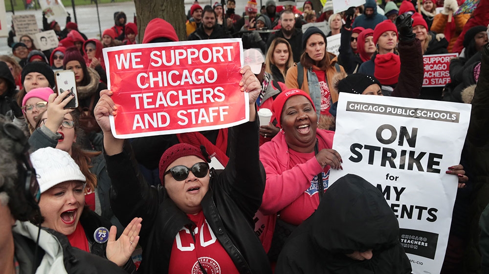 Striking Chicago teachers and their supporters rally outside of Oscar DePriest Elementary School