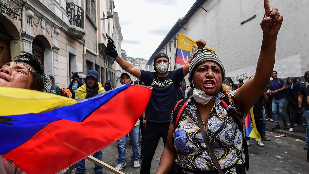 Demonstrators shout slogans during clashes with riot police as thousands march against President Lenin Moreno’s decision to slash petrol subsidies