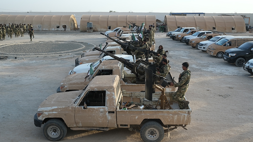 Turkey-backed members of Syrian National Army prepare for moving to Turkey with heavy armed vehicles for an expected military operation by Turkey into Kurdish areas of northern Syria, in Azas near Tur