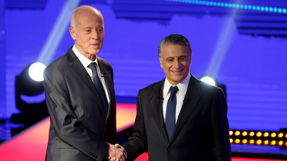 Tunisian presidential candidates Nabil Karoui and Kais Saied shake hands before a televised debate ahead of Sunday''s second-round runoff election in Tunis