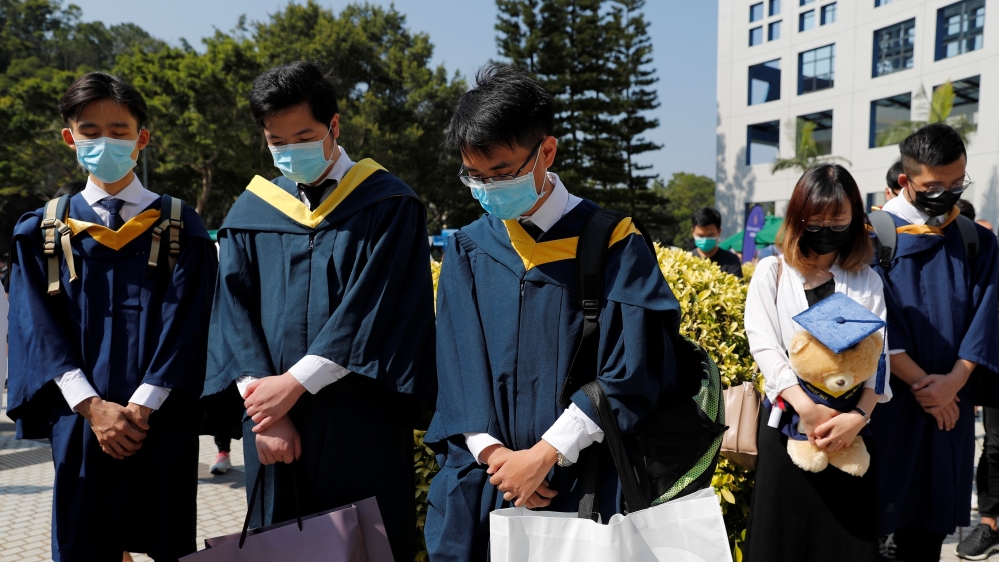 Students attend a ceremony to pay tribute to Chow Tsz-lok, 22, a university student who fell during protests at the weekend and died early on Friday morning