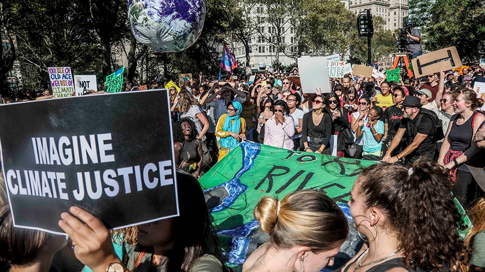 Climate change activists bounce around a floating earth ball during a climate strike rally, as part of a global youth-led day of global action in New York
