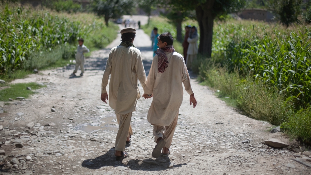 Afghan boys holds hands while leaving their school Monday, Sept. 5, 2011 in the village of Asmar, Kunar province, Afghanistan. (AP Photo/David Goldman)
