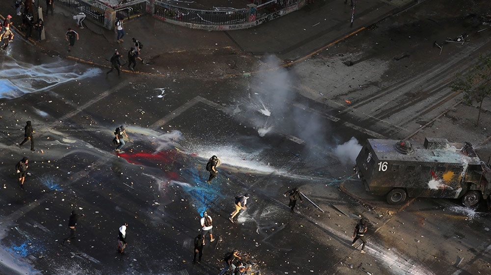 Demonstrators clash with riot police during a protest against Chile’s government in Santiago, Chile