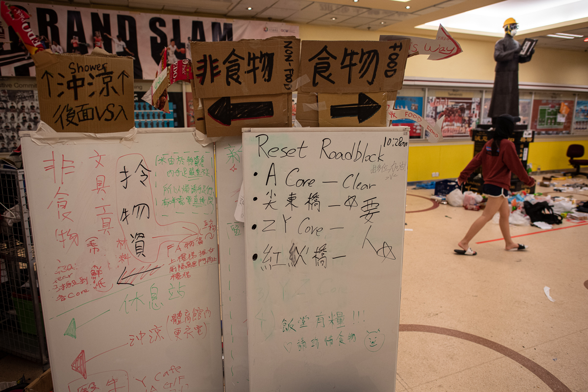 A general view shows a statue and stuff in an entry area of a canteen inside the Hong Kong Polytechnic University in the Hung Hom district of Hong Kong on November 20, 2019. - A dwindling number of ex
