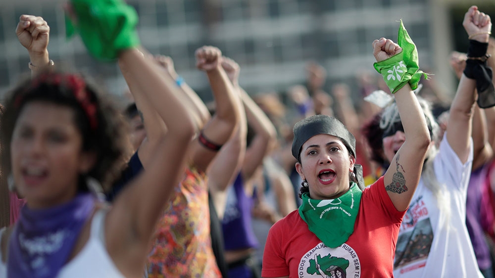 Women perform the feminist anthem ‘A rapist in your path’, in a demonstration against gender-based violence in front of Planalto Palace in Brasilia, Brazil