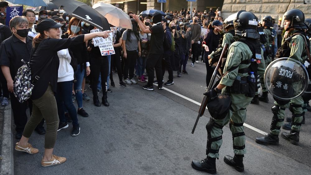 Riot police block a section of Hong Kong as tens of thousands of protesters flooded the city on December 1