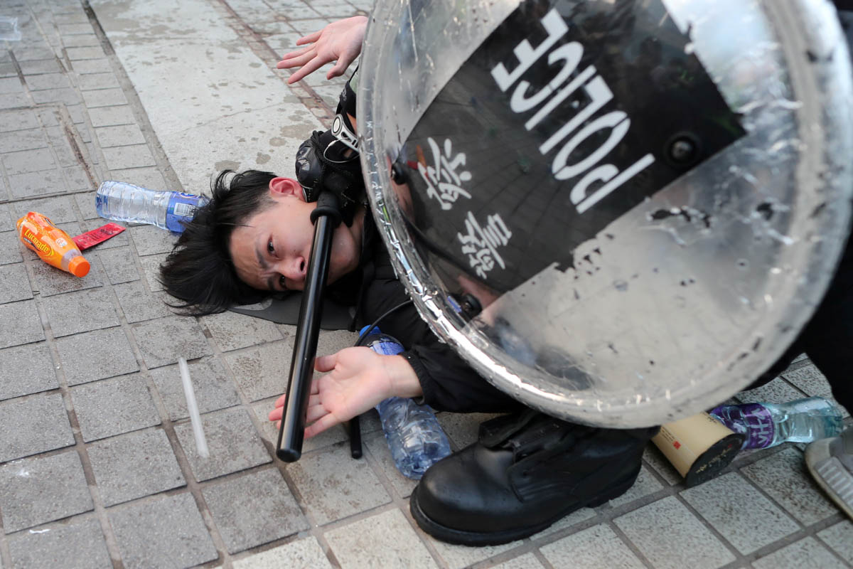 Police arrest a Hong Kong protester after a Chinese flag was removed from a flag pole at a rally in support of Xinjiang Uighurs'' human rights in Hong Kong, China, December 22, 2019. REUTERS/Lucy Nicho