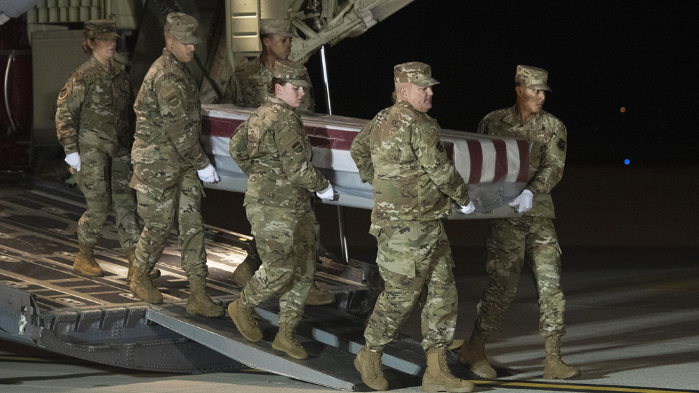 Members of the US Air Force carrying the remains of Navy Ensign Joshua Watson who was killed in the December 6, 2019 shooting in the Naval Air Station Pensacola in Florida