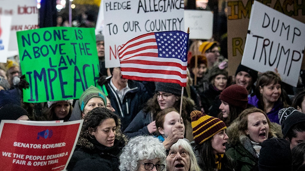 An anti-President Trump crowd gathers at a rally to protest and call for his impeachment