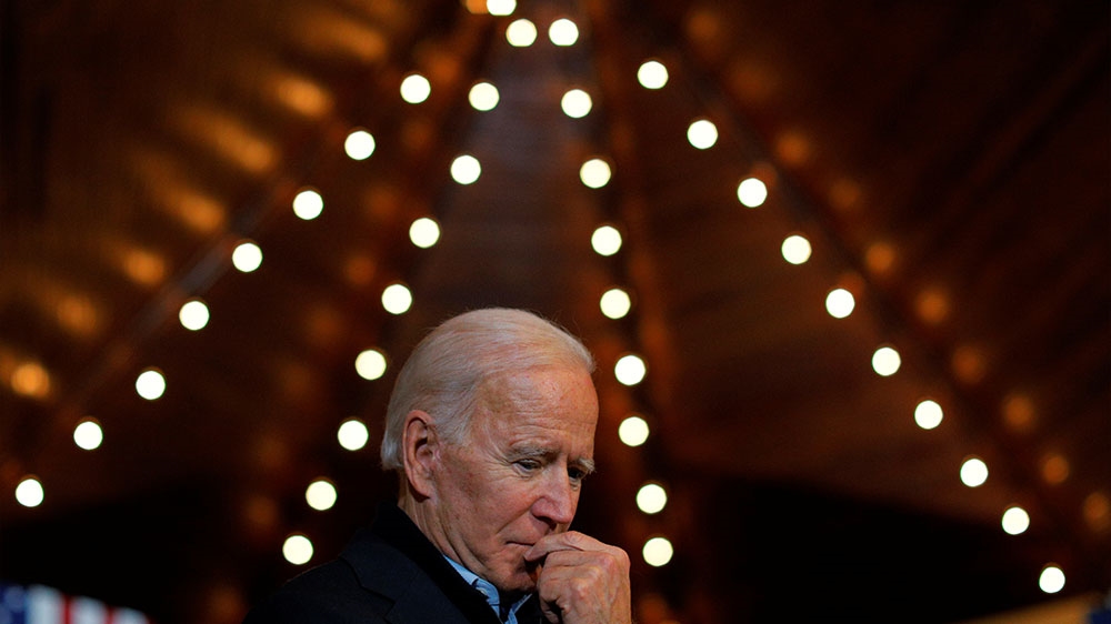 Biden listening while former Iowa Governor Tom Vilsack speaks at a stop on Biden’s ‘No Malarkey!’ campaign bus tour in Iowa