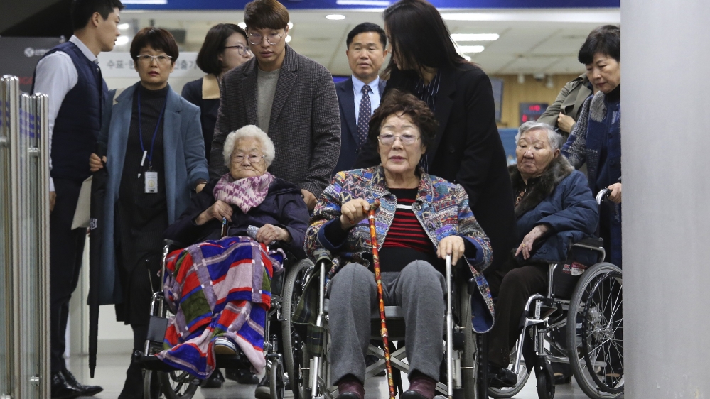 Former South Korean comfort women, Lee Yong-soo, (centre), Lee Ok-seon and Gil Won-ok, right, leave the Seoul Central District Court in Seoul in 2019