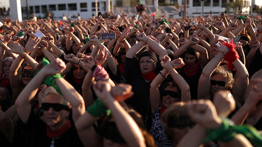 Women rights activists and people hold up their hands during a protest opposing violence against women and against Chile’s government in Santiago, Chile