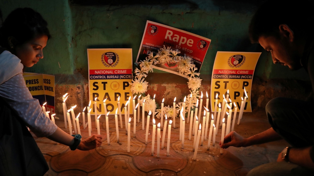 People light candles during a vigil as they attend a protest against the alleged rape and murder of a 27-year-old woman, in Kolkata