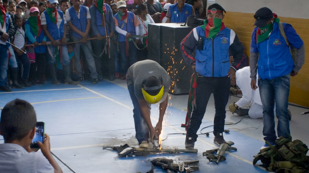 The Guard saws apart rifles they confiscated from a dissident guerrilla faction in Tacueyo, Cauca
