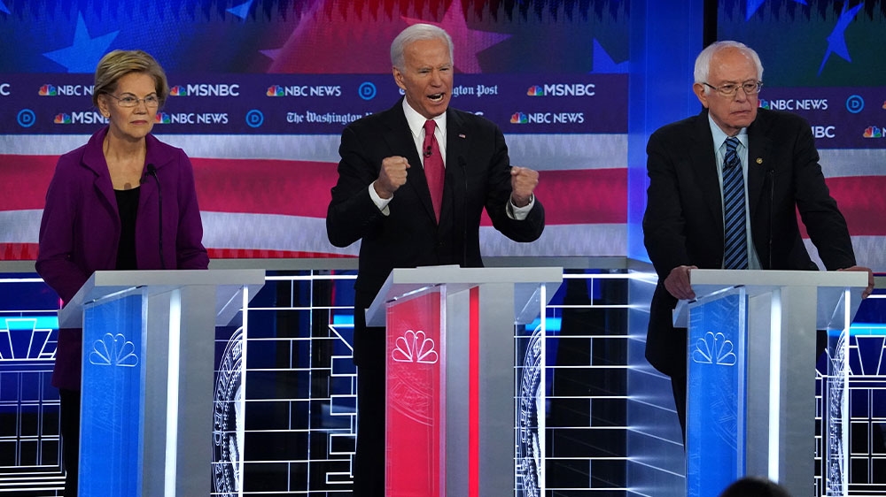 Joe Biden standing alongside Senator Elizabeth Warren and Senator Bernie Sanders during the fifth 2020 Democratic debate in Atlanta, Georgia, US