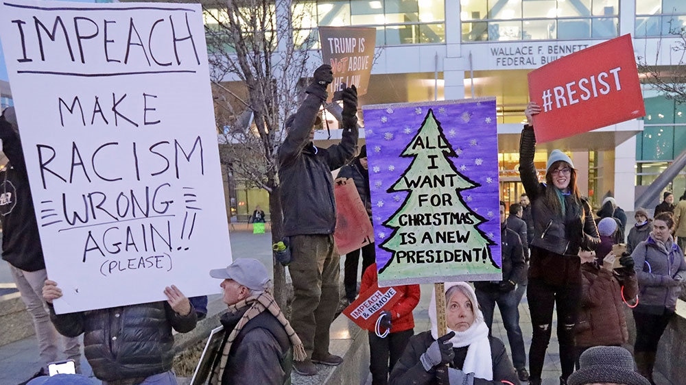 Supporters for the impeachment of President Donald Trump gather during a rally in Salt Lake City