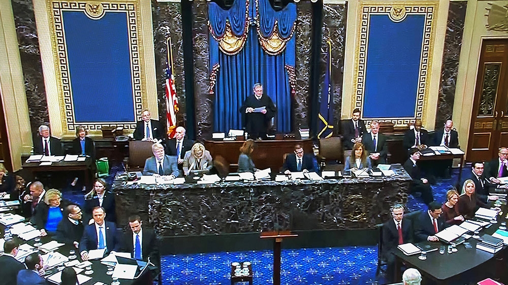 Supreme Court Chief Justice John Roberts presides over the start of the Senate impeachment trial of President Donald Trump as the House impeachment managers sit to one side and the president’s legal team sits on the other side in the Senate Chamber