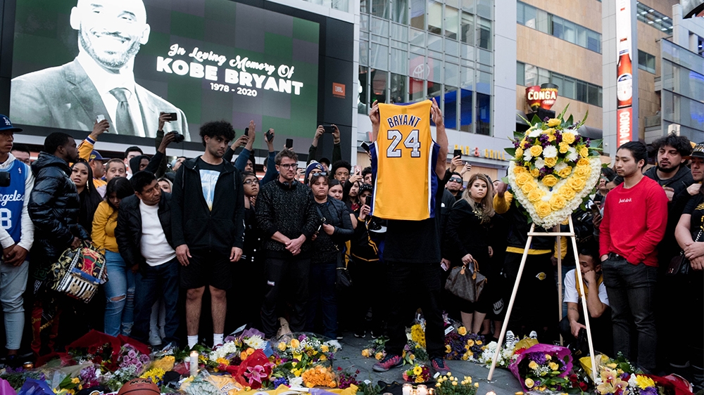 Fans gather at LA Live in Los Angeles to pay their respects to star basketball player Kobe Bryant who died in a helicopter crash on Sunday.